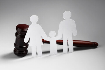Judge's gavel with family figure on light background