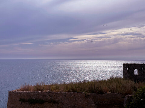 Mediterranean Sea, twilight sky and scenic coastline in the evening.