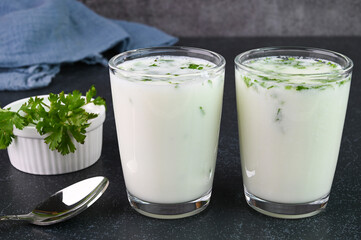 Serving buttermilk drink in glass cups.