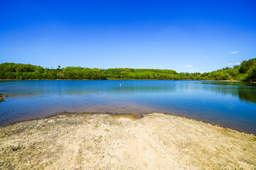 View of the Lingese Dam and the surrounding landscape near Marienheide. Nature by the lake in the Oberbergischer Kreis district.
