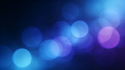 A beautiful abstract background of blue and purple glowing bokeh lights on a dark background