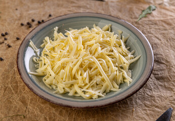 Shredded cheese filling a plate