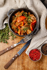 Dish with meat and vegetables served in a bowl on wooden table