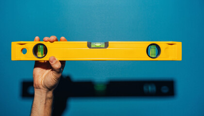 Measuring Precision, Subject: Hand with Spirit Level, Location: Indoor Setting, Content Type: Photography, Environment: Minimalist, Viewpoint: Close-Up, Concept: Focus on Accuracy