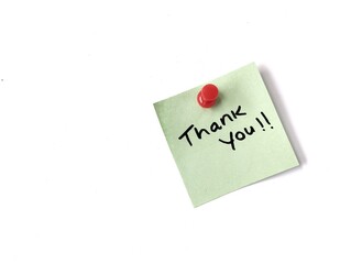 thank you message on green note paper with pin isolated on white background. Copy space 