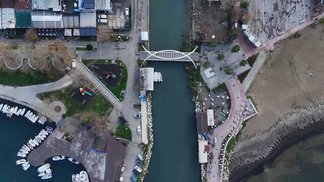 A scenic view of the water canal, bridge, and coastline of Yalova, Turkey, located near Istanbul along the Sea of Marmara. The scene captures the harmony between urban infrastructure and coastal natur