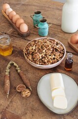 In a cozy Romanian kitchen, a clay oven gently releases steam as fresh colaci and mucenici sit on a wooden table, surrounded by ingredients evoking village warmth and tradition