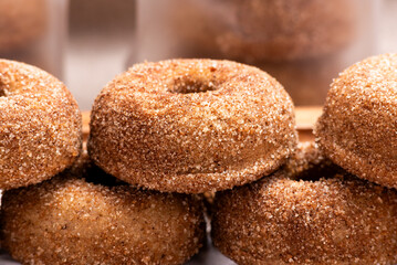 A delectable stack of freshly baked cinnamon sugar donuts presented. Close up. Citron donuts.