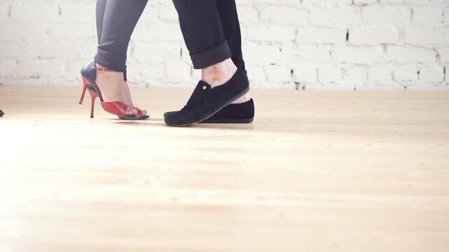Dancers feet - family couple is dancing kizomba in studio