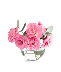Glass vase with beautiful pink eustoma flowers and eucalyptus on white background
