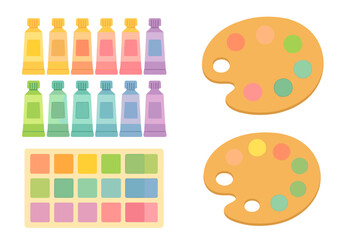 Colorful artist supplies including paint tubes and palettes ready for creative expression at a workspace