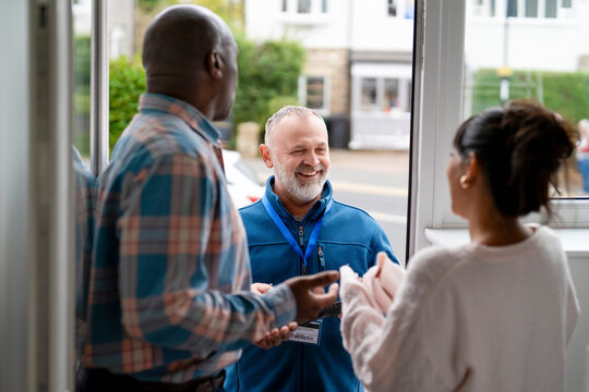 People talking in doorway in a bright setting during daytime