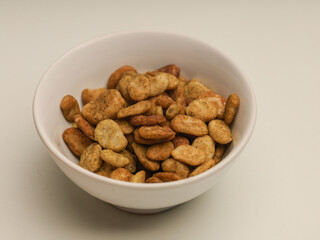 Bowl of Koro beans or jack beans on white background