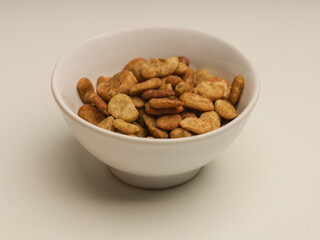 Bowl of Koro beans or jack beans on white background