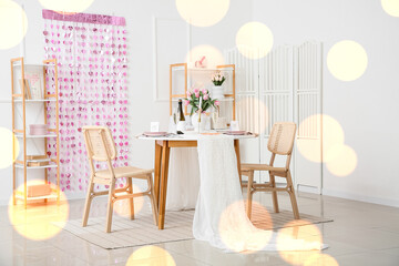 Interior of dining room with served table for Valentine's Day celebration