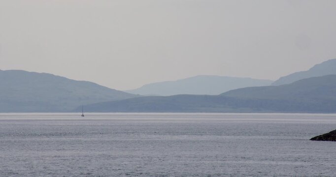 Long shot of the Misty Isle of Mull from Ganavan Bay at Oban