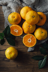 Fresh Oranges Over Natural Fabric on Wooden Table