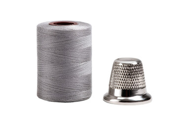 Silver thimble and spool of thread isolated on transparent background