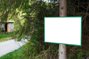 Close-up of small billboard with empty mockup in the woods.