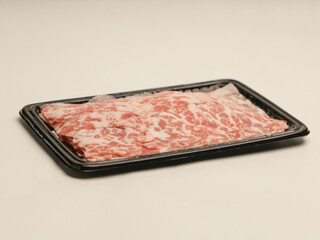 Raw meat on plastic tray