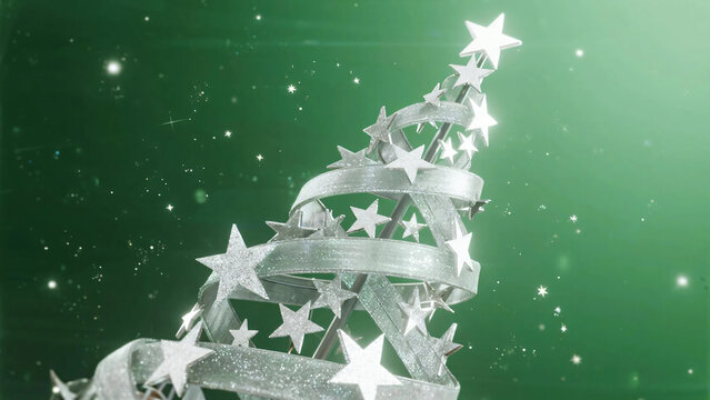 Christmas mini sponge cake with silver star topper on green background with fir trees