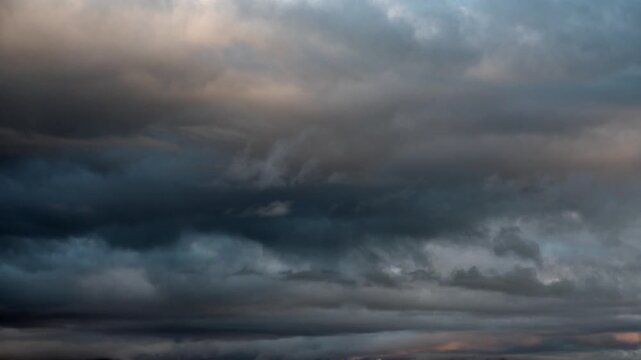 Timelapse of variable dark storm clouds moving across the sky before rainfall. Dramatic cloud formations shift rapidly, signaling approaching severe weather conditions.