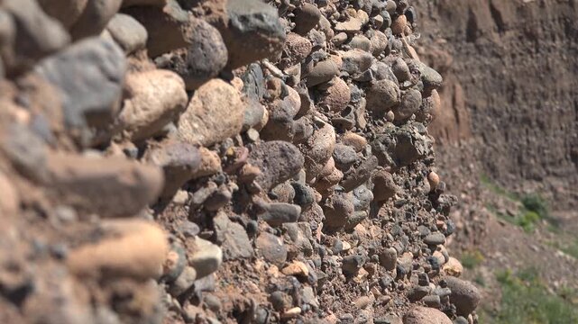 Different forms in cross section of soil horizon layers revealing texture and structure. Natural earth profile shows stratified sediments and geological patterns in ground materials.