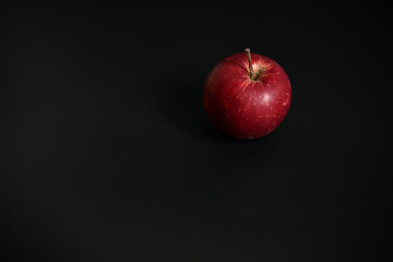 High-contrast studio shot highlighting the smooth peel of the apple. Perfect for themes of healthy diet and simple, bold food advertising.