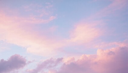 Obraz premium Filling frame pastel clouds over open sky showing layers at dawn, with warm sunlight
