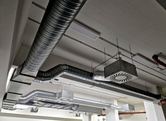 The photo shows an industrial HVAC system, including ductwork and air filters. The system provides air supply and exhaust, conditioning, and distribution throughout the building.