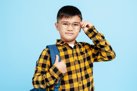 Asian schoolboy learning with glasses, backpack, confident for school studying