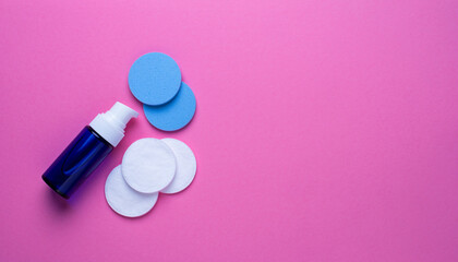 Cosmetic Skincare Essentials Foam Cleanser and Cotton Pads on Pink Background