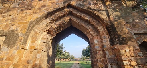 Medieval Pointed Arch and Ancient Rubble Masonry Stone Wall of the Feroz Shah Kotla Fort Ruins 