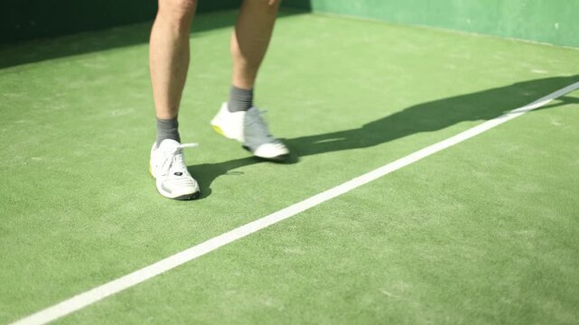 Male padel tennis player footwork training on green court