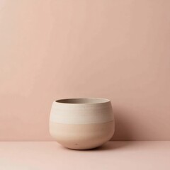 Minimalist ceramic pot with subtle texture against a soft peach background
