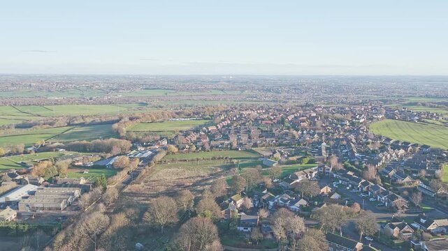 Historic brick infrastructure of Caphouse Colliery, now the National Coal Mining Museum, and the encroaching suburban residential development, Overton district in West Yorkshire, England, aerial