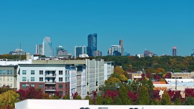 Buckhead, Atlanta, Georgia, United States of America - Mid-rise Apartments and Colorful Autumn Trees Sit in the Foreground, with Buckhead&rsquo;s Modern Skyline Rising Sharply Behind them - Static Shot