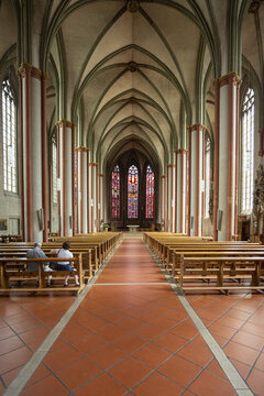 View of grand arches rise above rows of wooden pews, at St paulus dom Cathedral, Muenster, North Rhine-Westphalia, Germany.