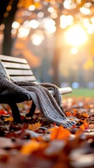 Empty Park Bench Covered in Autumn Leaves with Golden Sunset Backlight Illuminating the Scene