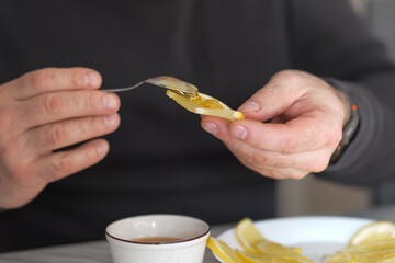 Golden nectar being spread on a tart citrus, a sweet remedy for a winter's chill
