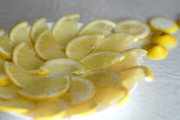 Luminous lemon slices gleaming on a plate, an aromatic and vibrant springtime still life