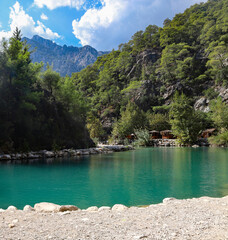 Small pond in the mountains with turquoise water in Goynuk canyon,  Turkey. Emerald lake in the forest surround mountains.