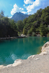 Small pond in the mountains with turquoise water in Goynuk canyon,  Turkey. Emerald lake in the forest surround mountains.