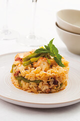 Baked rice with octopus and seasonal vegetables.