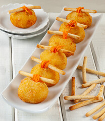 Cheese and carrot-stuffed fingers. Kids' food.