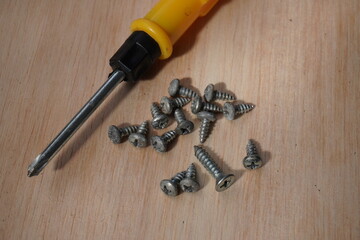 screwdriver and screws on wood