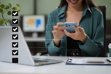Naklejka premium Business performance checklist concept, businesswoman using smartphone and laptop doing online checklist survey, filling out digital form checklist.