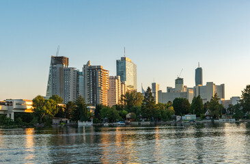 Vienna business skyline in summer. Romantic Sunset at the Alte Donau with view to office buildings.