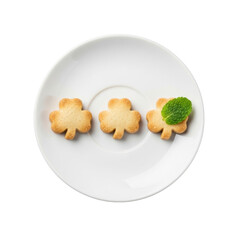Three shamrock cookies on white plate with vibrant mint leaf, isolated transparent, sharp macro focus, food photo, gourmet treat concept