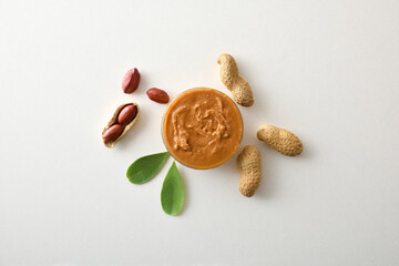 Peanut butter in a bowl and peanuts in the center